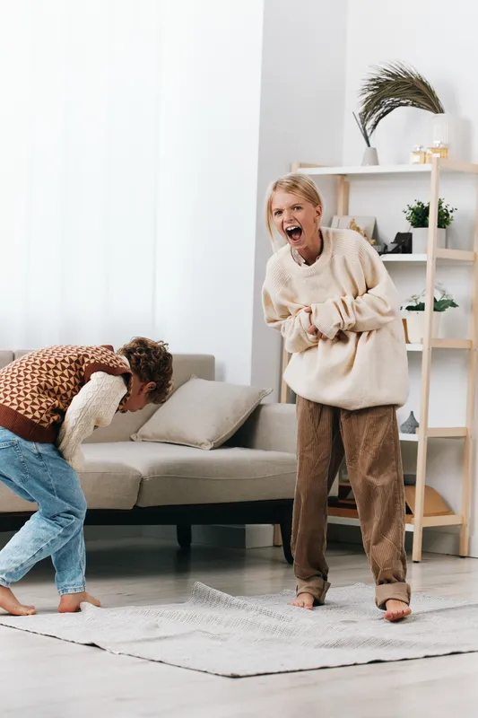 Authentic depiction of playful youngsters in a home setting, capturing a genuine game moment, bright smiles, and spontaneous laughter during everyday life.