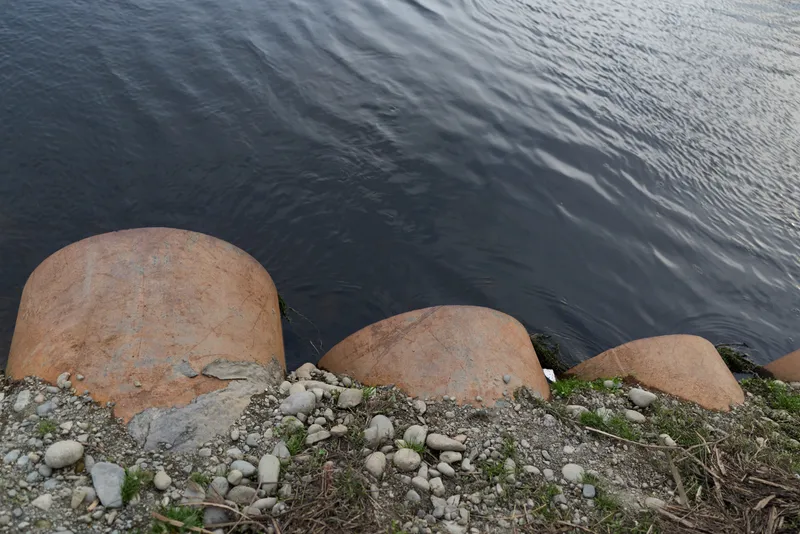 Shoreline, rocks, pebbles, water, ocean, coast, nature, calm, outdoor, relaxation, stone edge with small waves, wet boulders and gravel texture, peaceful lifestyle background