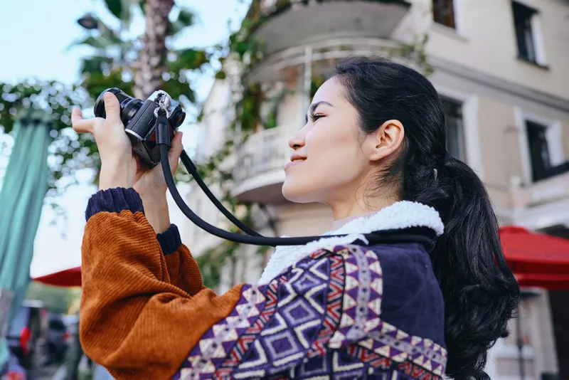 Camera, photography, woman, outdoor, city, street, lens, shoot, photographer, lifestyle capture of a person holding a camera and framing a moment in an urban setting during daylight