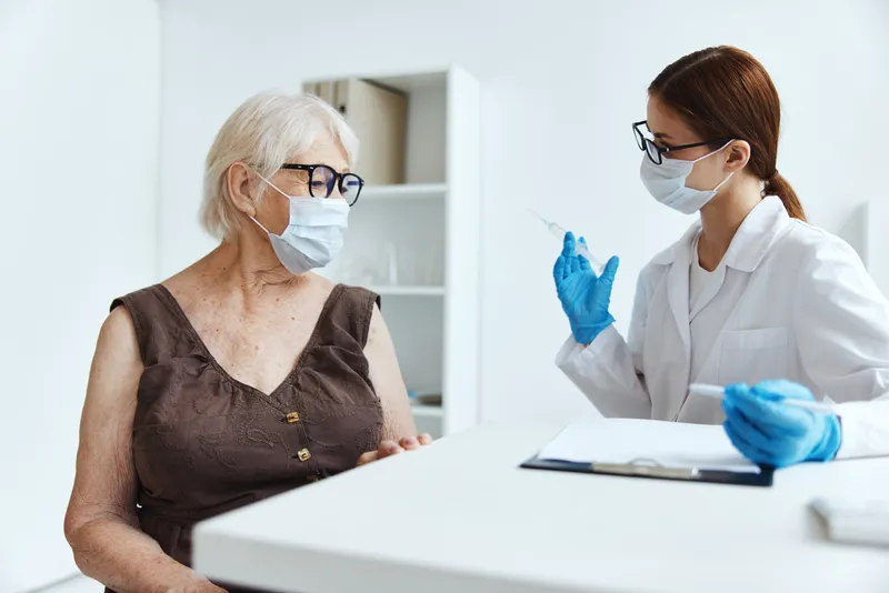 Пожилая женщина-пациентка в больнице для вакцинации и защиты иммунитета