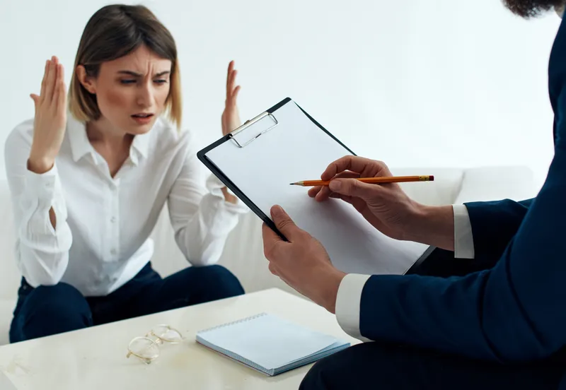 Женщина-психолог работает с пациентом, имеющим проблемы в общении