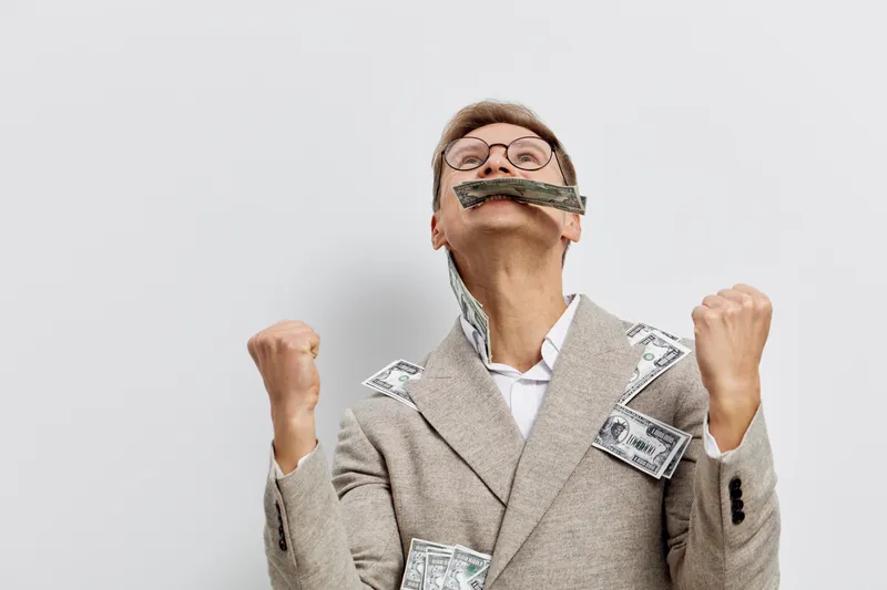 excited man celebrating success gray suit holding dollar bills clenched fists mental health and gadgets concept