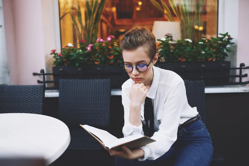 Девушка на улице с книгой в руках