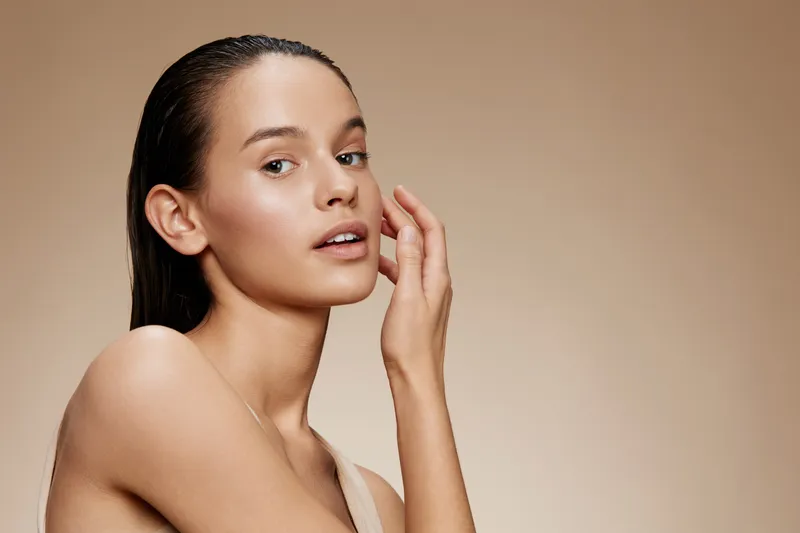 Close up portrait of a young model with natural makeup, demonstrating healthy skin and emotions, perfect for beauty and skincare concepts