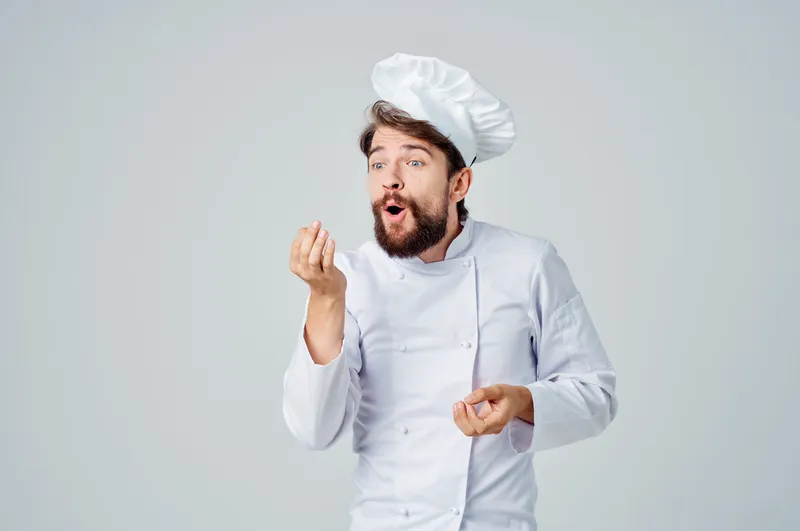 Шеф-повар занимается кулинарным искусством на изолированном фоне