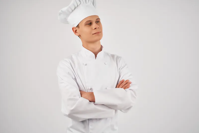 Шеф-повар мужского пола занимается приготовлением пищи, работая профессионально