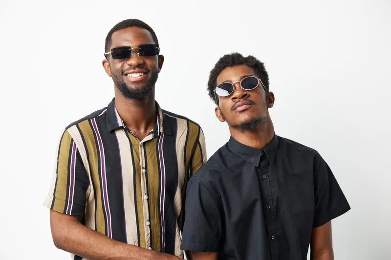 Stylish African American men in trendy sunglasses showcase a confident and fun vibe. Perfect for fashion and friendship themes in lifestyle photography.