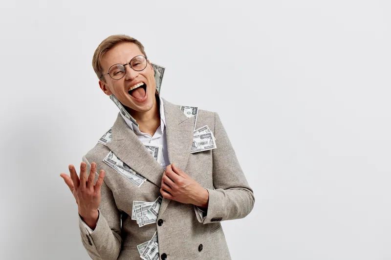 Smiling woman with short hair wears stylish blazer and glasses for a cheerful studio portrait. She appears happy and confident, expressing joy and positivity. Concept: happiness, fashion, professional