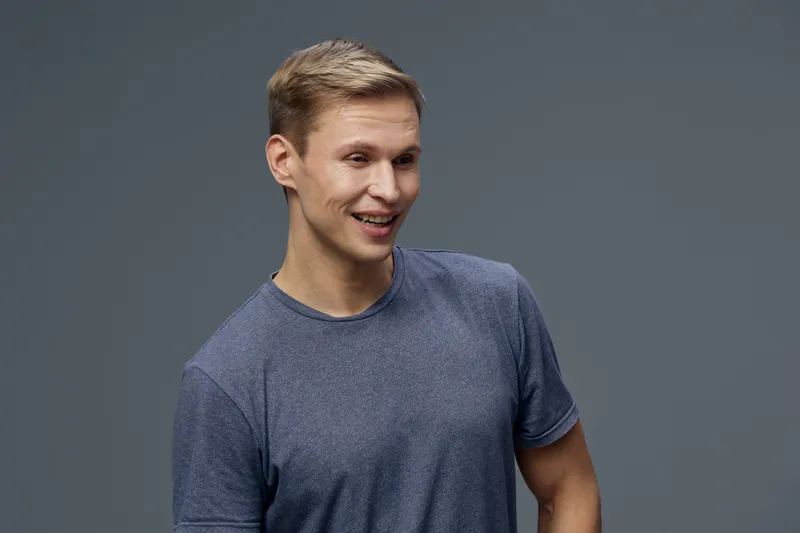 Smiling young caucasian man cyber security casual wear look side dark background studio portrait digital safety concept