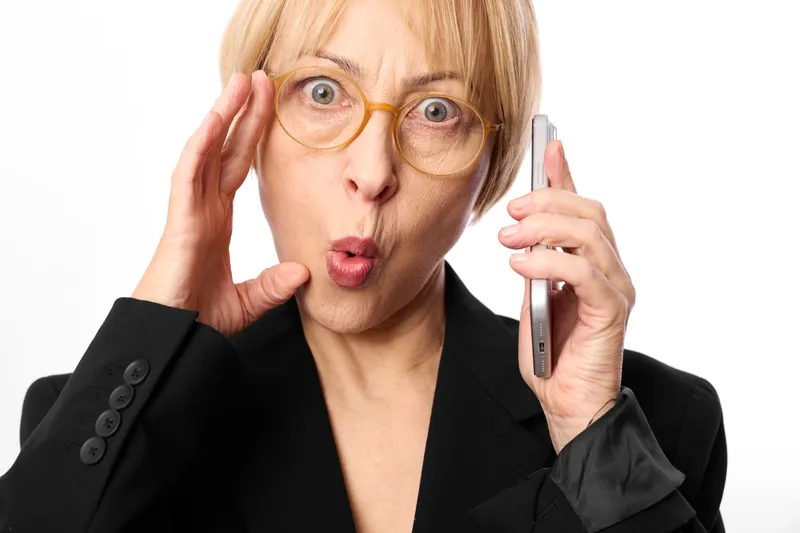 Woman, phone, surprised, glasses, business communication, call, suit, aged woman answers smartphone, surprised expression, hand near temple, white background