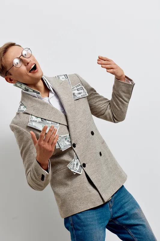 excited man with money bills in blazer casual wear expressive happy young caucasian businessman standing isolated on plain white background finance concept