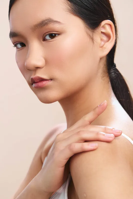 Asian woman portrait in soft, flattering light, closeup of clear skin and calm expression, highlighting beauty, skincare, and graceful elegance for lifestyle imagery.