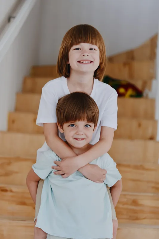 Happy children playing together at home, bright atmosphere, smiling faces, engaging interaction. A joyful moment of childhood captured in a cozy setting.