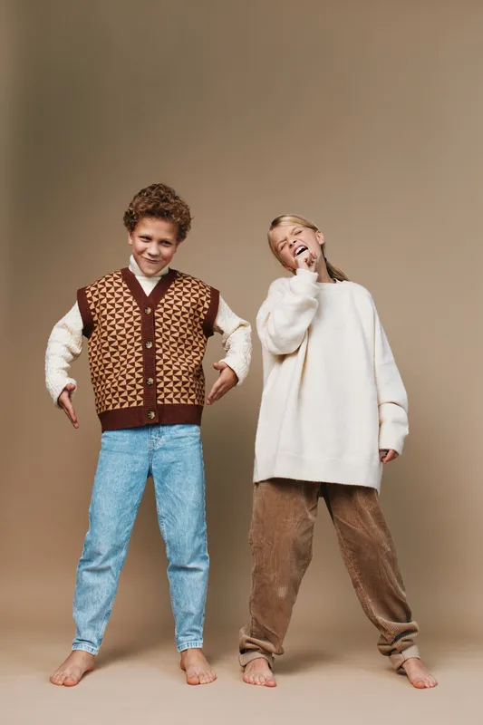 Authentic playful scene of children in school inspired outfits, capturing candid motion, confident posture, and genuine smiles for lifestyle and education themed stock photography.