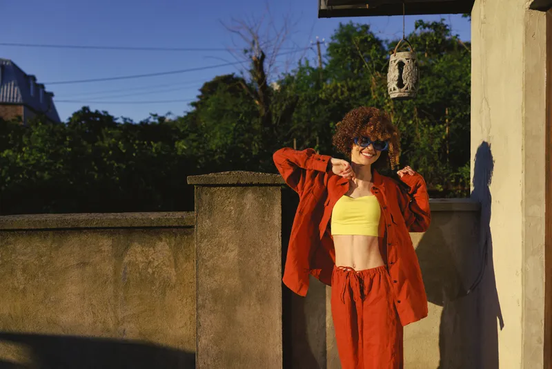 Woman lifestyle outdoor fashion casual sunny jacket top in a bright street scene, a confident pose and relaxed mood capture a stylish everyday moment