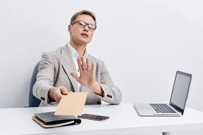 young caucasian man working digital detox refusing smartphone push back hand rejecting modern technology office interior white background