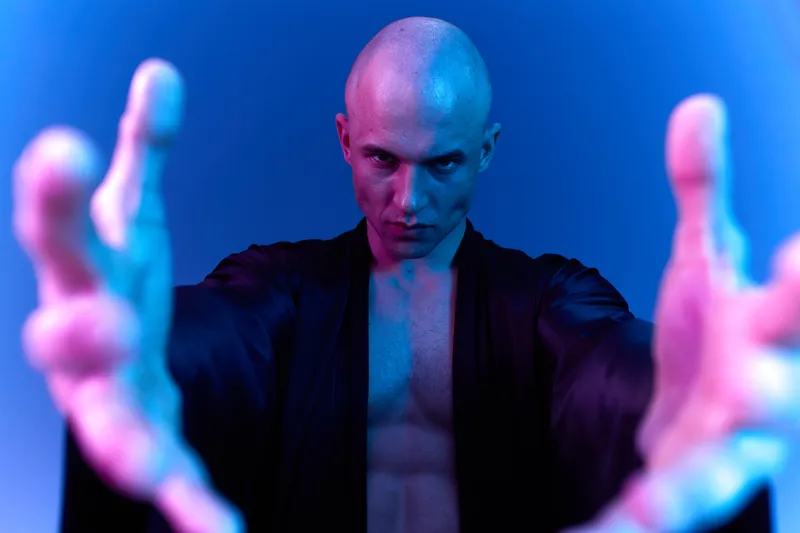 Dramatic man extending hands, showcasing a powerful expression and bold colors, emphasizing intensity and emotion in a captivating black and white style.