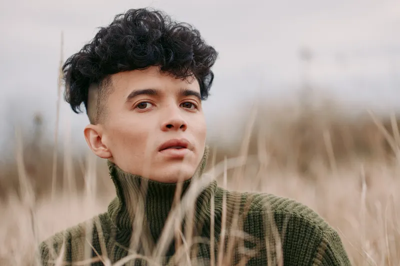 Portrait of a thoughtful subject in soft natural light, conveying authenticity and veracity through honest gaze and subtle texture of clothing.