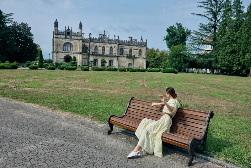 woman bench mansion park authenticity inclusivity, woman reads on bench in park near mansion