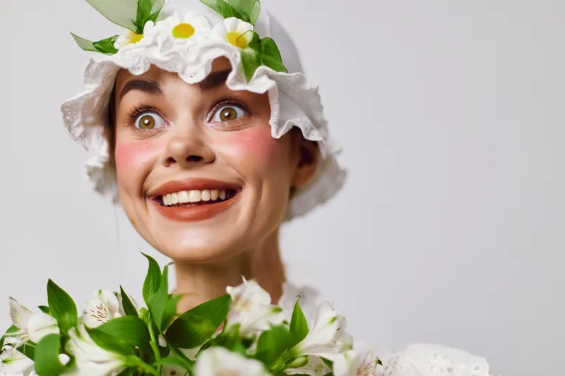 Cheerful young woman in floral hat, smiling broadly with a bouquet, bright colors, fresh spring vibe, ideal for seasonal greetings and nature themed projects