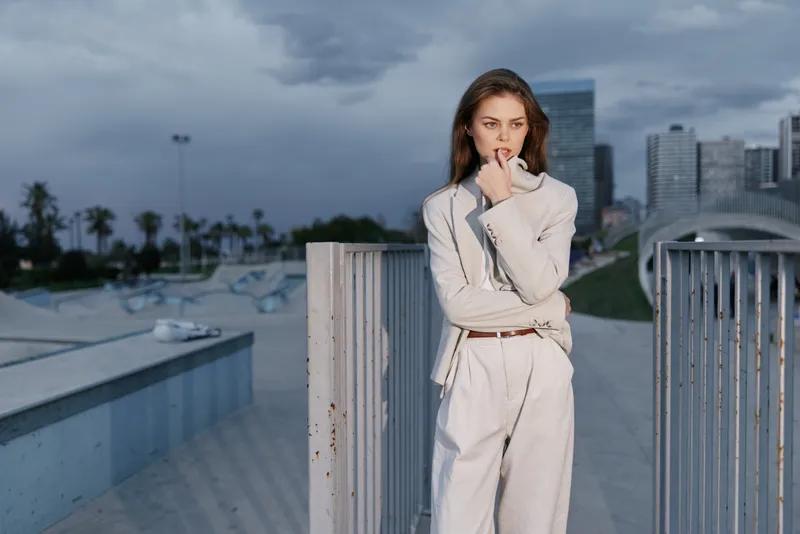 Young woman in beige suit pensive outdoors urban background financial crisis concept