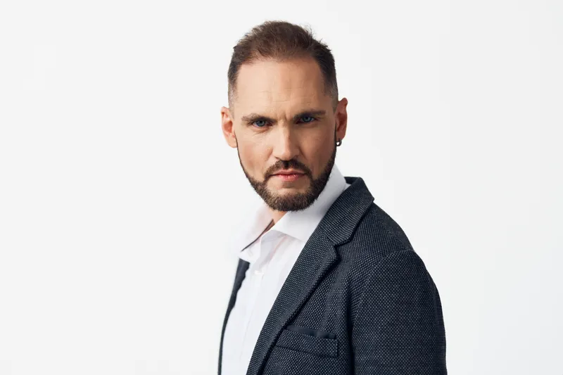 Theme: a business professional man exudes confidence and focus against an isolated colored background. This portrait conveys calm leadership and a poised, strong presence.