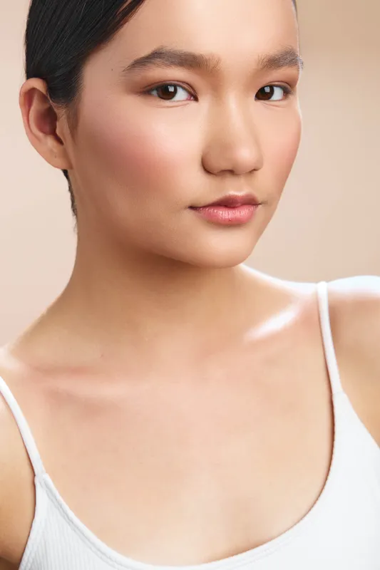 asian woman portrait in soft studio lighting with calm expression and smooth, glowing skin, conveying elegance and poise for beauty, fashion, and lifestyle projects.