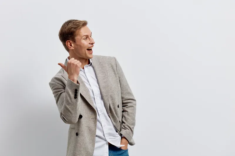 young man talking on mobile phone casual wear smiling happy communication digital nomad concept isolated gray background