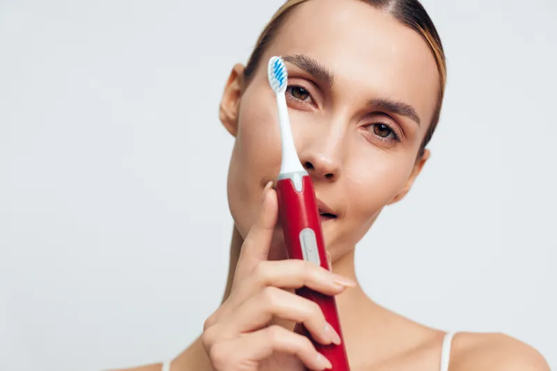 Skincare woman face beauty selfcare closeup routine roller cheek wellness, white studio background, gentle treatment, soft light, smooth skin and calm relaxation