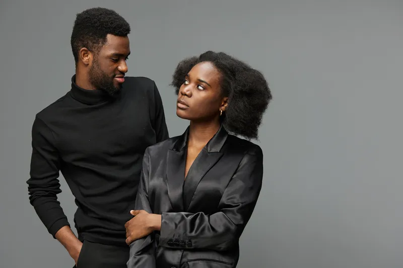 Stylish African couple in elegant attire with confident emotions, perfect for love and relationship concepts