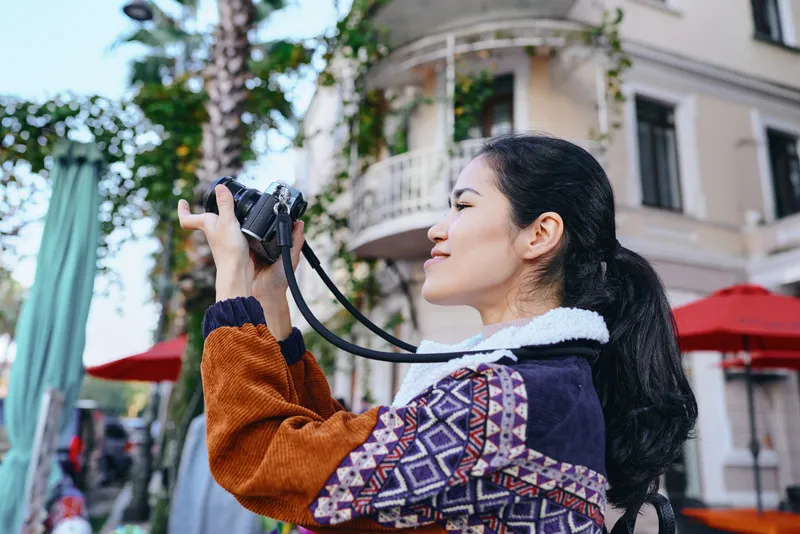 Camera photography woman street outdoor urban lens view captures candid moment, street life, architecture and cityscape with natural light, showcasing dynamic composition and vibrant urban vibes