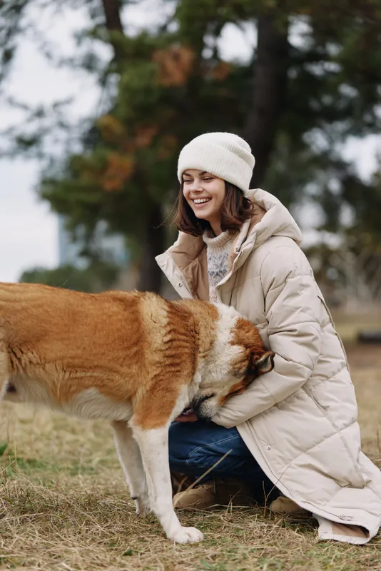 woman, dog, outdoor, affectionate, winter, coat, park, cuddling, jacket, warm, field, smiling, gentle, pet, friend, companion, nature, serenity, cozy, comfort, breeze, autumn, fall, landscape, quiet,