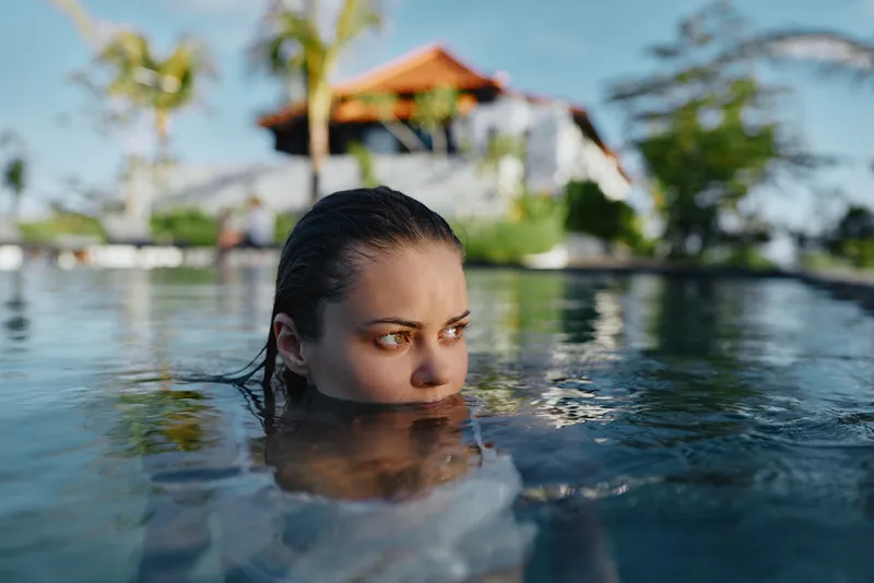 Water pool woman swimming in a resort setting, vacation mood and leisure vibe, relaxation and wellness focus, sunny tropical atmosphere creating a calm refreshing lifestyle
