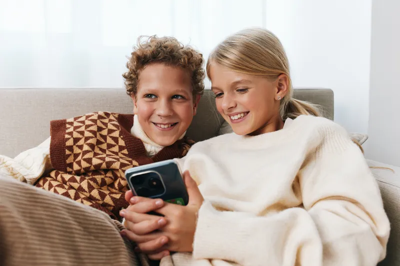 Authentic scene of children enjoying a playful moment at home, a cozy lifestyle portrait showing learning spirit and school curiosity during a relaxed afternoon.
