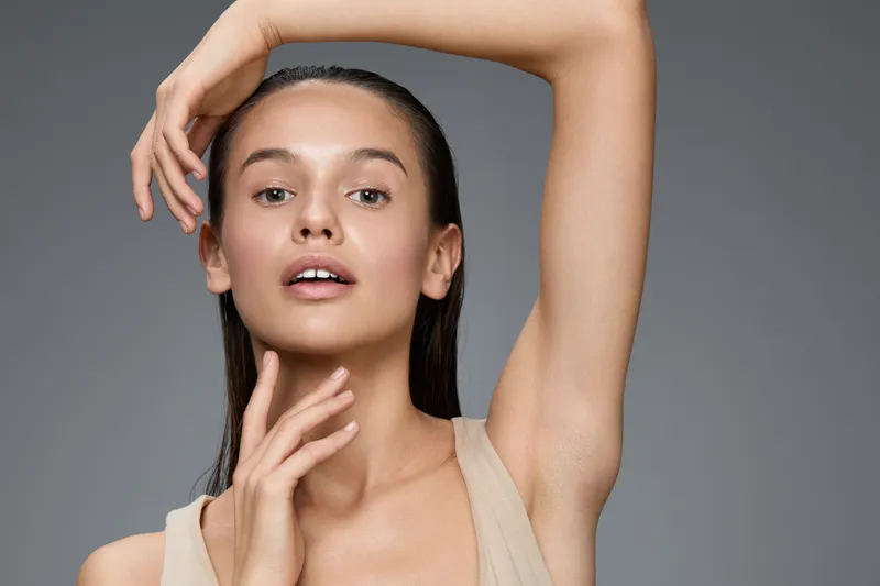 Young woman with natural beauty posing gracefully, showcasing healthy skin and a serene expression, suitable for wellness and beauty concepts