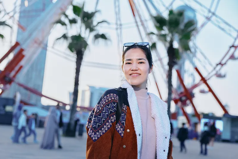 street, outdoor, fashion, woman, cardigan, sunglasses, urban, plaza, leisure, cityscape, candid lifestyle scene of a stylish figure in a patterned cardigan with sunglasses, walking through a sunny