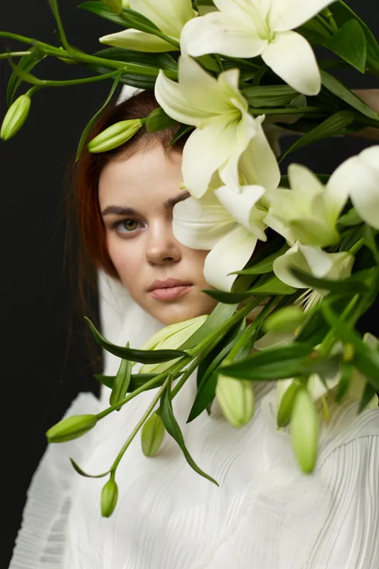 A serene portrait of a young woman with flowers, showcasing beauty, elegance, and nature to enhance wellness and tranquility