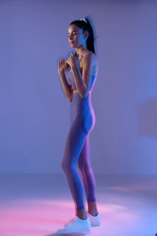 woman sport fitness in purple activewear practicing boxing stance, focused young athletic Asian female with ponytail, modern studio lighting, vibrant pink and blue tones