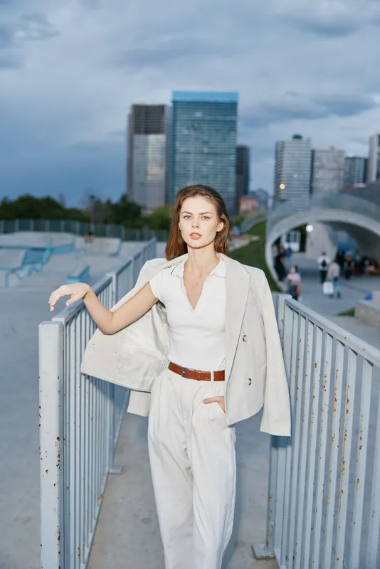 Confident woman in business attire against a modern cityscape, exuding elegance and professionalism for corporate settings.