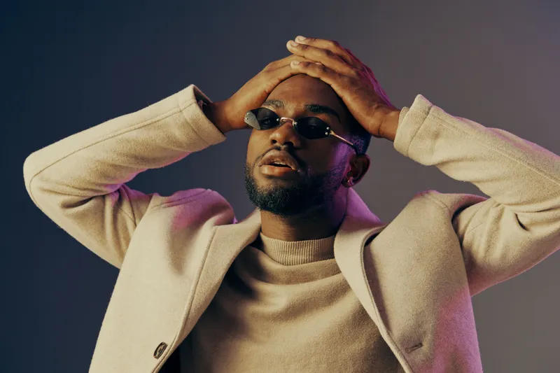 Stylish young man with sunglasses showing emotions against a colorful background, reflecting contemporary fashion trends and self expression