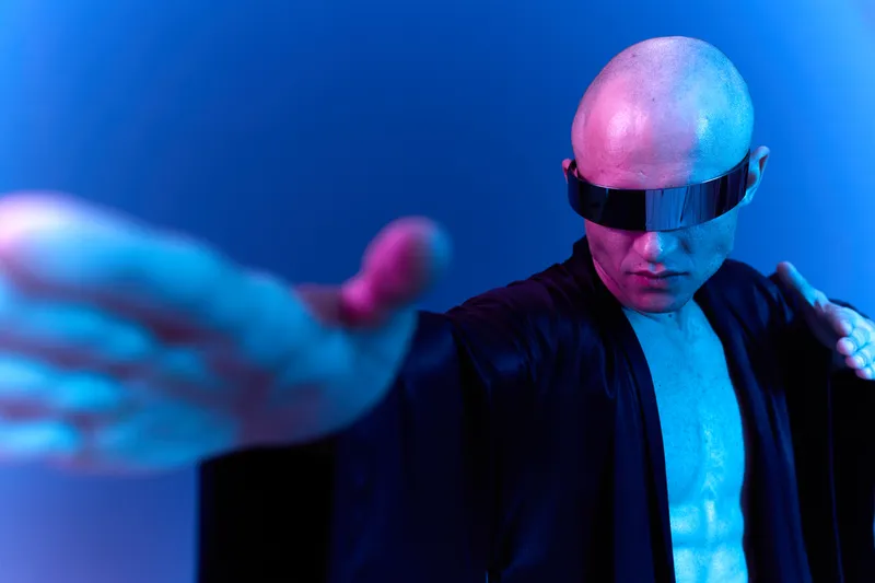 Confident man in futuristic attire, showcasing a powerful gesture. The blue and purple lighting creates a striking contrast against his skin tone.