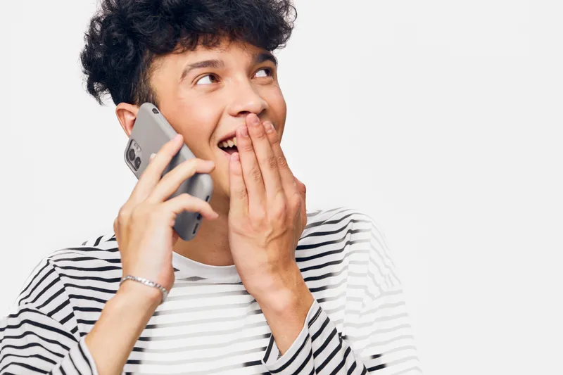 smiling man talking on smartphone smiling surprised happy casual modern lifestyle communication concept