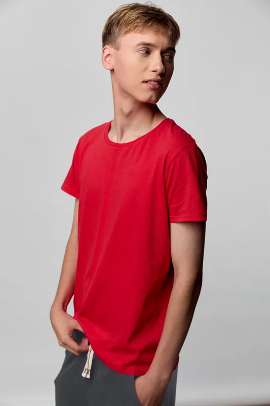 Red t shirt casual wear with clean studio setting, showcasing fit, fabric and relaxed style for everyday fashion and youth appeal, highlighting color, texture and minimalist design