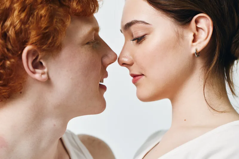 Couple, man and woman close together looking into each other's eyes for romance and love. Portrait with intimate and gentle expression, connection, relationship, affection at home.