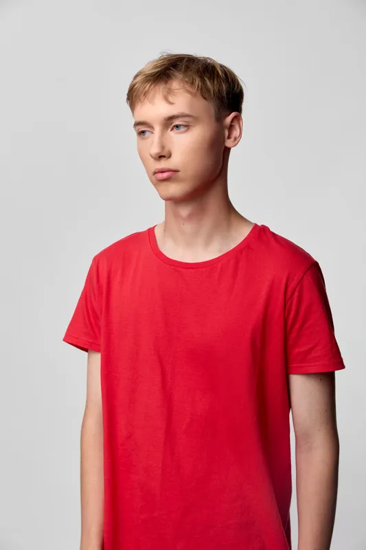 Young man, red t shirt, casual fashion, studio shoot, male model, lifestyle, fashion, neutral backdrop, minimal styling, everydaywear, clean composition, calm expression, bright lighting, versatile