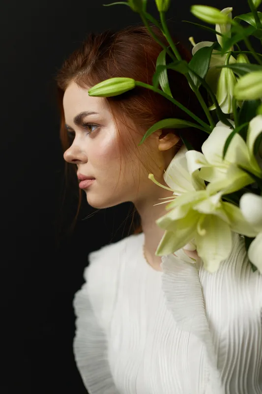 Beautiful young woman with flowers, showcasing natural beauty and elegance, perfect for spring themes, healthy lifestyle, and fashion concepts