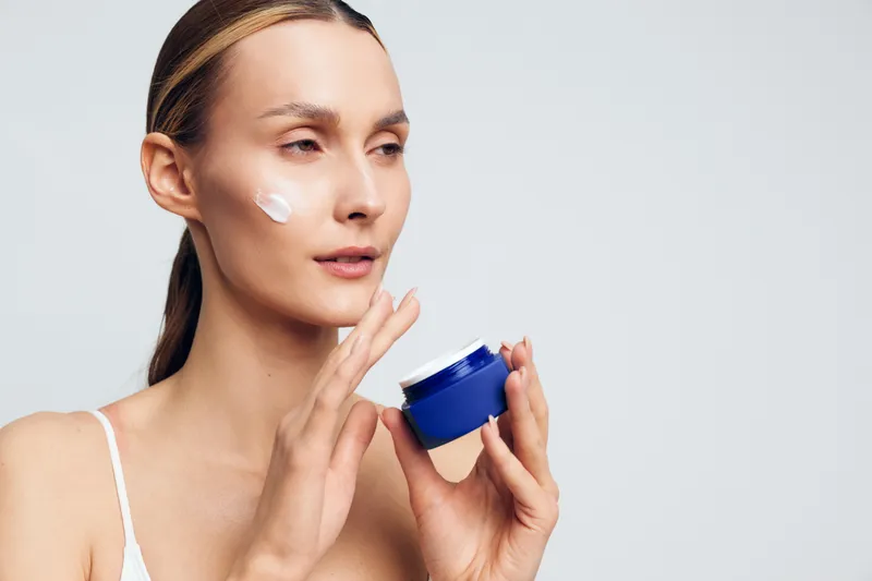 Woman skincare, face cream, beauty jar, care cosmetic, moisturizing lotion for smooth fresh complexion, calm female model, clean light background, portrait close up