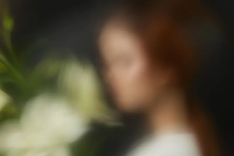 Ethereal portrait of a woman with flowing red hair holding a bouquet of white flowers, symbolizing beauty, serenity, and nature s grace during spring