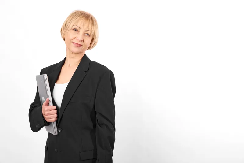 Businesswoman woman in black suit, portrait in studio, smile and holding folder with documents, professional adult confidence on white background, copyspace for communication
