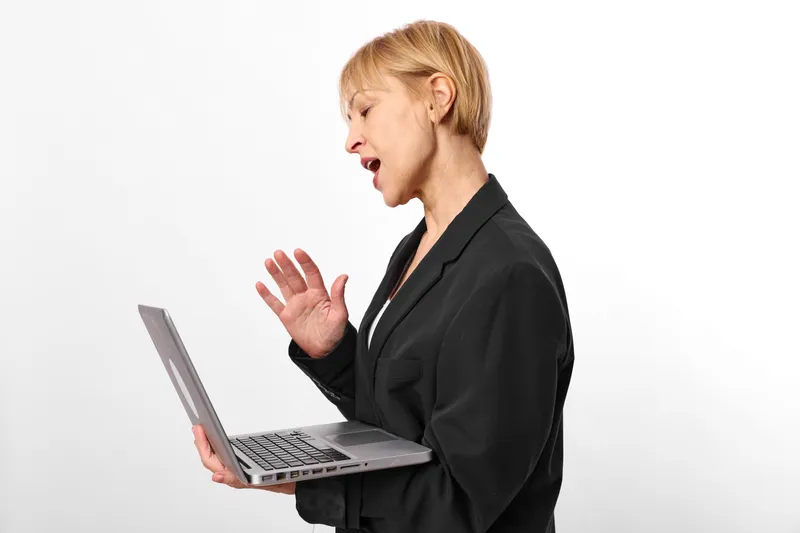 Woman with laptop in office profile speaking with raised hand, communication, fatigue and stress, technology on white studio background, concept of business